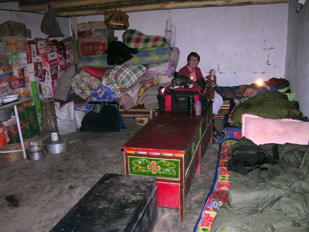 Tibet Guge 01 To 06 Sangsha Sleep We slept in the kitchen at Sangsha with supplies lining the walls and legs of meat hanging from the ceiling. It was very comfortable.